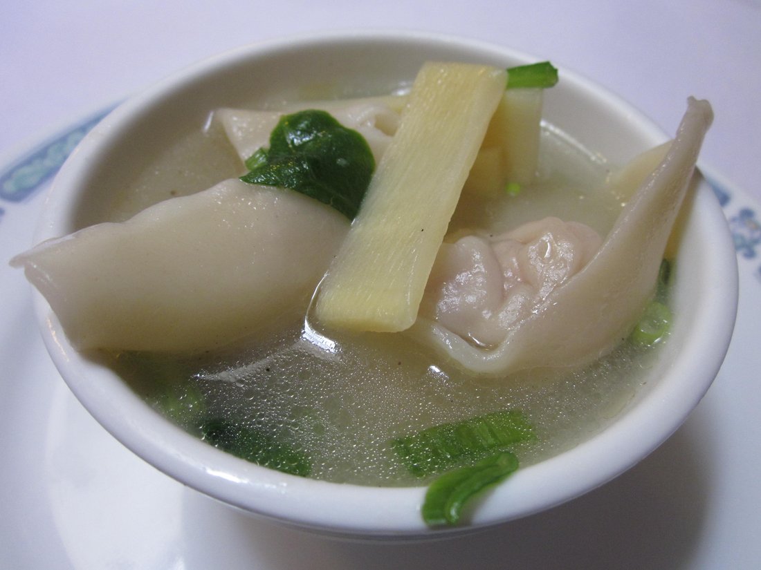 A bowl of wonton soup, photographed from above